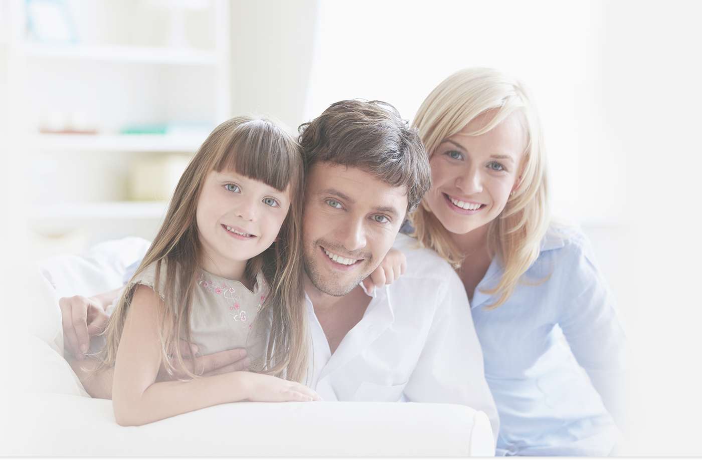 Family of three on couch smiling