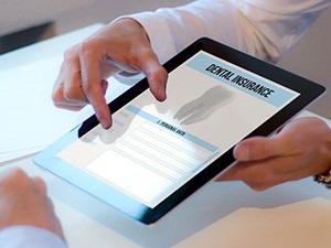 Patient reviewing dental insurance form on tablet