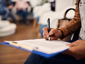 Patient filling out paperwork in lobby