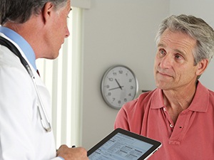 dentist and patient discussing the cost of dental emergencies in Fayetteville 