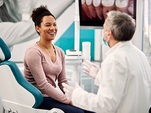 Woman smiles at Fayetteville emergency dentist during appointment 