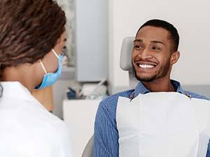 Man smiling at his emergency dentist in Fayetteville