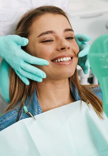 patient smiling in dental mirror