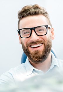 patient smiling while sitting in treatment chair 