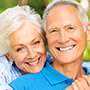 Elderly couple hugging and smiling