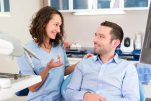 cosmetic dentist talking with patient