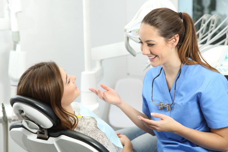 dentist speaking to patient about color-matching dental crown